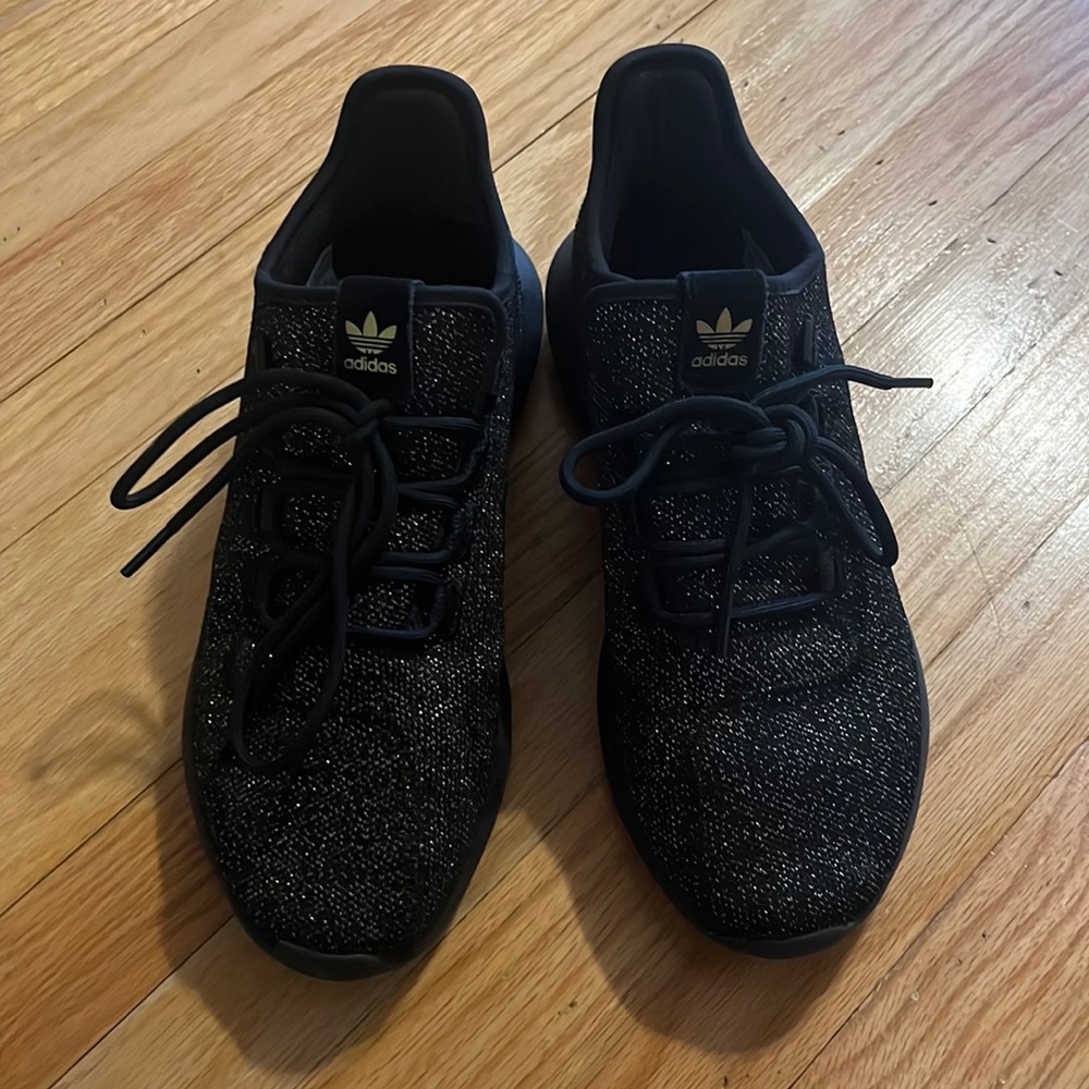Black and gold Adidas sneakers